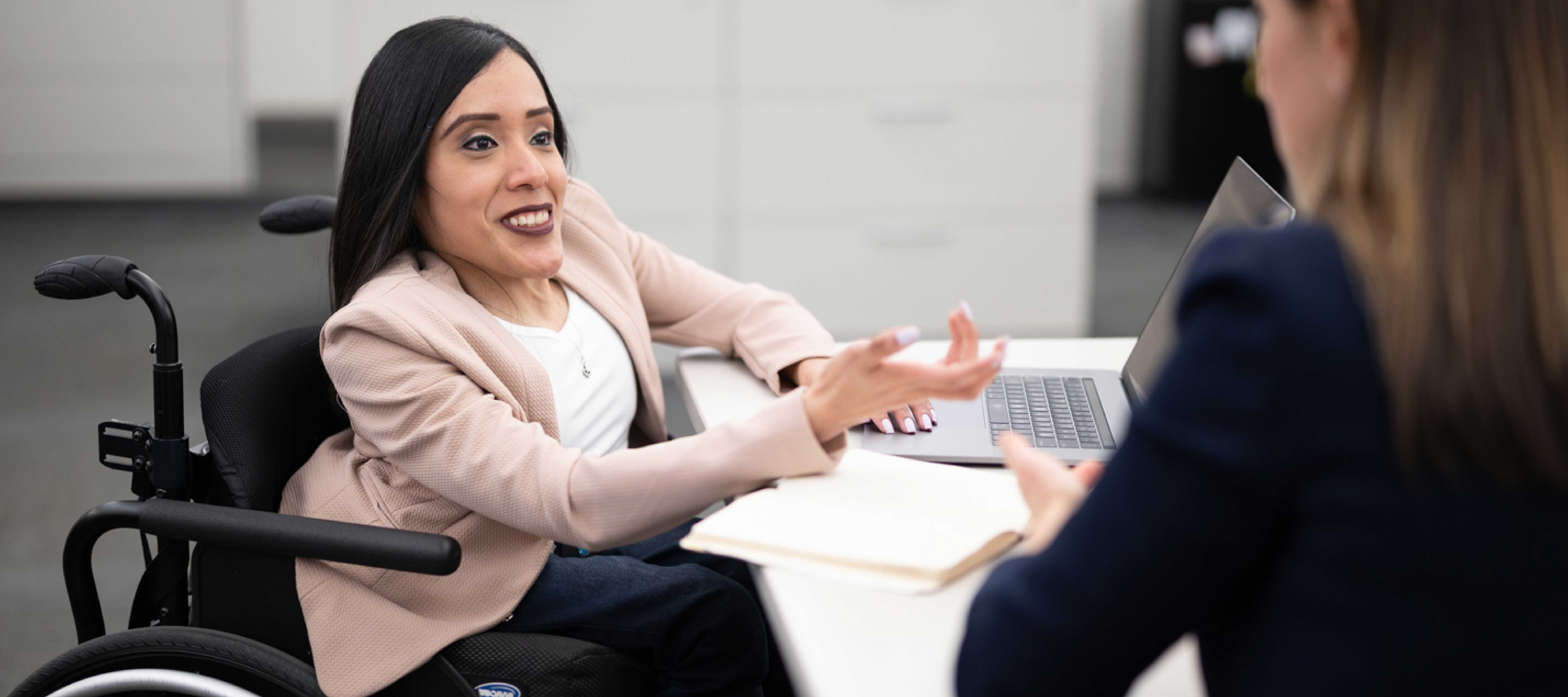 Wheelchair user having office meeting with colleague