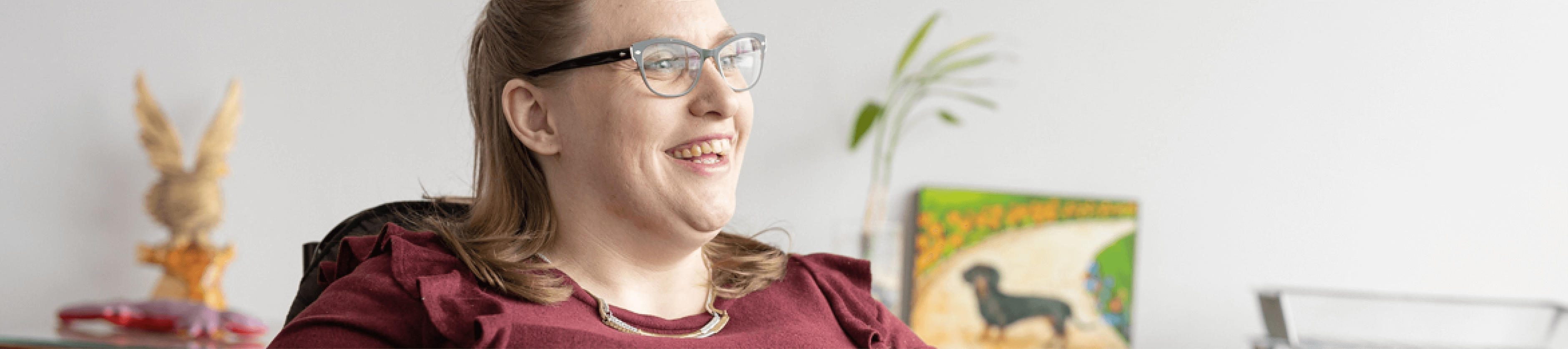 Office worker with disability smiling across room